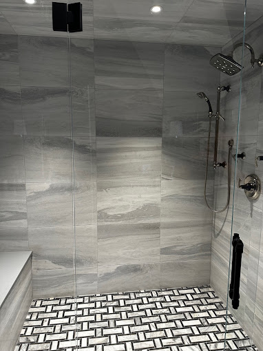 A walk in shower sitting next to a white toilet
