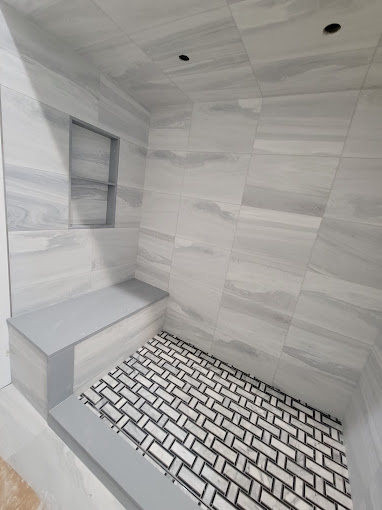 A bathroom with a tiled floor and walls